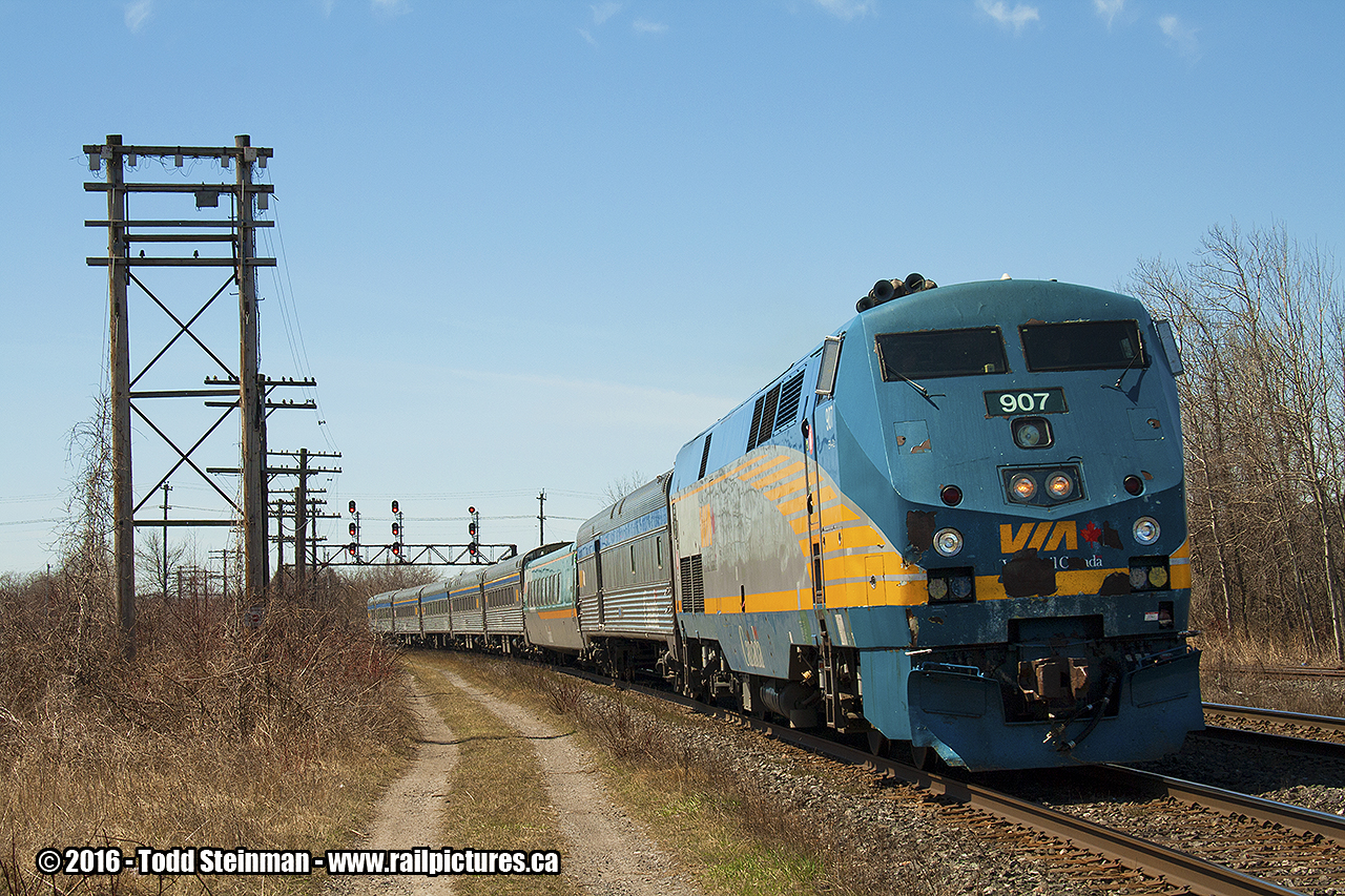 VIA 907 leads eastbound train 64 slowly around the bend as it approaches the station. Time of arrival is approximately 12:30 pm.