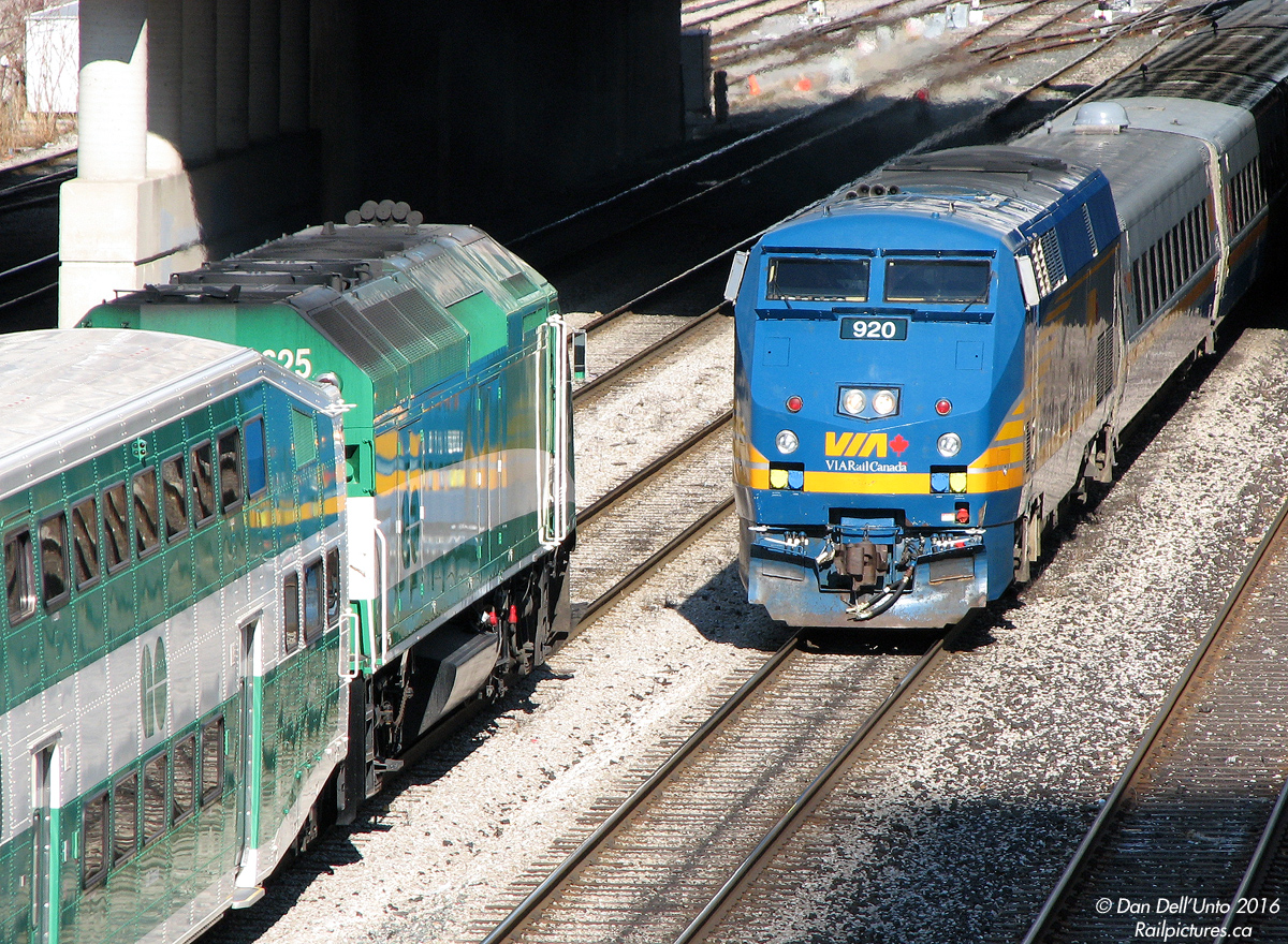 "Afternoon Sam" "Afternoon Ralph"

Reminiscent of the Looney Tunes sheepdog and coyote checking in at the beginning of their shift, VIA P42DC 920 at the head end of equipment move #87 backs past GO MP40PH-3C 625 on the head end of equipment move #412 paused at Peter Street overpass (renamed Blue Jays Way) near Spadina, both destined for Toronto's Union Station where they will begin their evening shifts by taking on homeward-bound passengers.