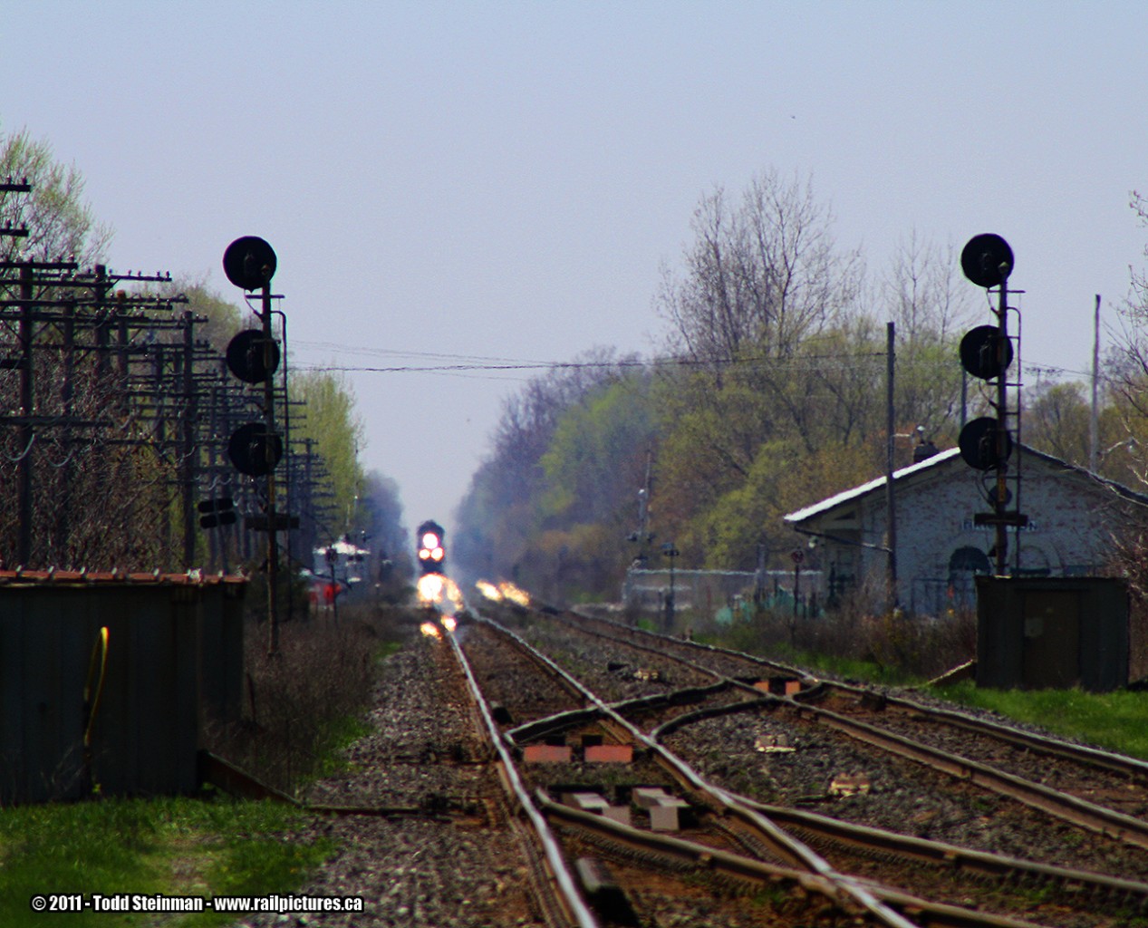 ANY TIME CAN BE TRAIN TIME!  My wife and I were in the midst of a long and grueling day trip up to Picton, when we stopped in a parking area between the CN Kingston Sub, and the CP Belleville Sub for some lunch. After 20 minutes, we decided to continue our trek home to Jarvis, when I hopped out and took a look down the CN line...sure enough, in the distance, it was going to be train time!

This would turn out to be VIA 6408, warpped in the Coors Silver Bullet theme, leading it's entourage of stainless steel cars as it headed east towards it's next station stop at Belleville.