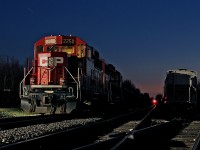 <b> Idling ECO's </b> A beautiful spring day comes to a close, but it's another day on the railroad, a clear signal in the far background adorns the westward signal at Guelph Jct. for a westbound freight that's climbing the hill. The gentle sound of two 8 cylinder turbocharged 710G3's from this pair of GP20C-ECO's idle away in mainline one track with a tie train from London.
