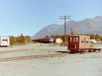 [Editors note: Photos of WP&Y freights are very rare online] While working in Whitehorse I took the time to drive down to Carcross with the idea of photographing the train station. While there I was lucky enough to catch a south bound train just as it entered town. The lead locomotive was #98. The sun was out. It was a perfect day to catch the action & the history while walking around town.