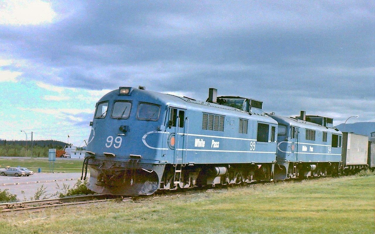 After a day of working at the old army base, I took the time to walk down into Whitehorse in order to get some exercise. As I got near the old river boat I noticed WP & YR train as it was heading north towards the station/yard area, & I caught the head end just as it passed by my location. Little did I know that the line would cease operations in a few months!