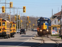 Conductor John Sharpe is keeping an eye for pedestrians and motorists alike that are not aware they are sharing the road with a larger force. This is the once a week SOR train 598 that serves the only remaining customer on the old Burgord spur. The one time Southern Pacific GP9 has one car in tow and will lift four more before returning to the CN yard in town.
