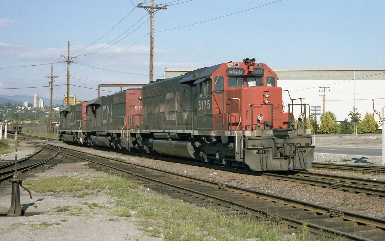 3 standard CN SD40,s have just delivered a transfer of open hoppers to the BCR in North Vancouver. Sitting just east of the passenger depot, the crew is waiting for the ok to return to home rails. A sign located just across from the station warns CN crews they are not permitted past that point. Unfortunately was not able to get the sign in the picture.