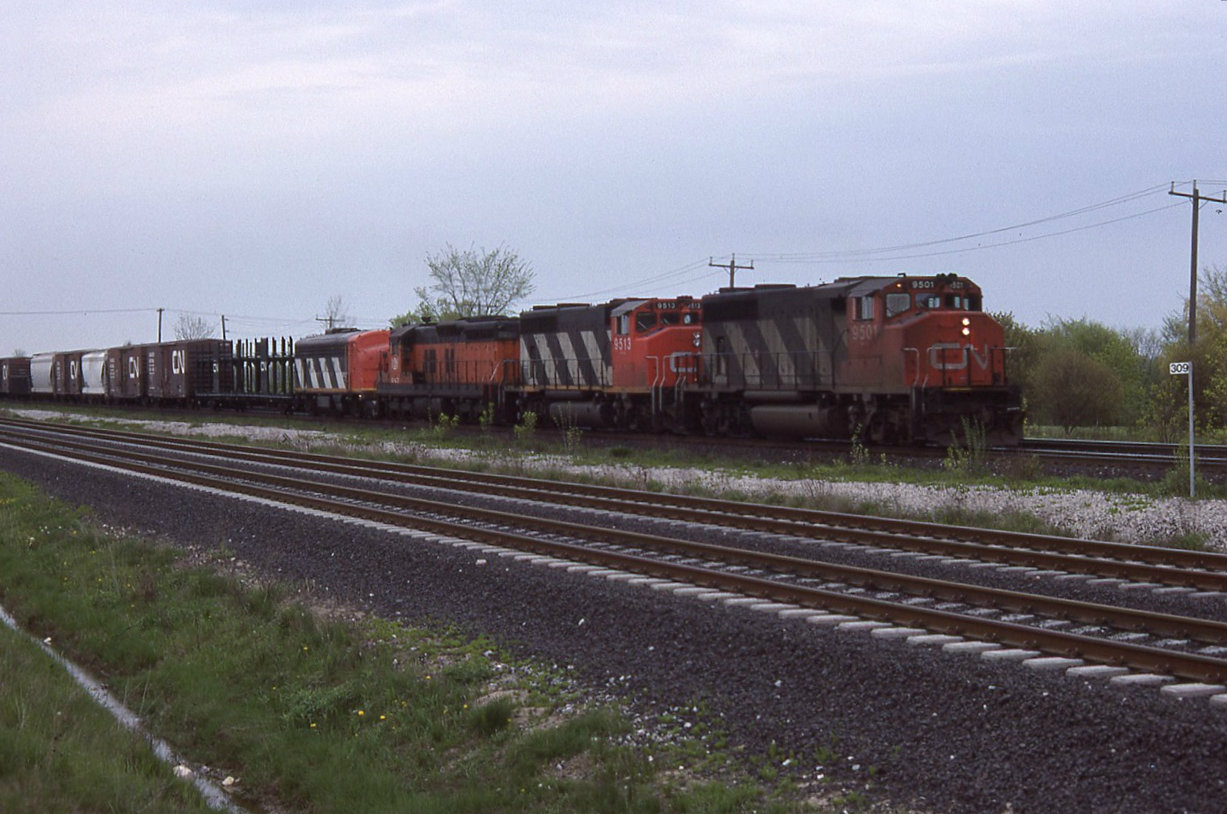 Not the best weather or scenery but how could you pass this up CN WB 9501 9513 B&LE 843 and a CN 9106 with the cab windows blanked out . Only by chance while walking around the new GO sub that this came about for a photo.
