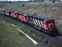 CN M636 2339 with B&LE SD9,s 841 & 823 along with an unidentified CN F unit round the curve east bound at Plug hat road toward the top end of Barr on the York sub. Both of the B&LE units where scrapped in 2000. 