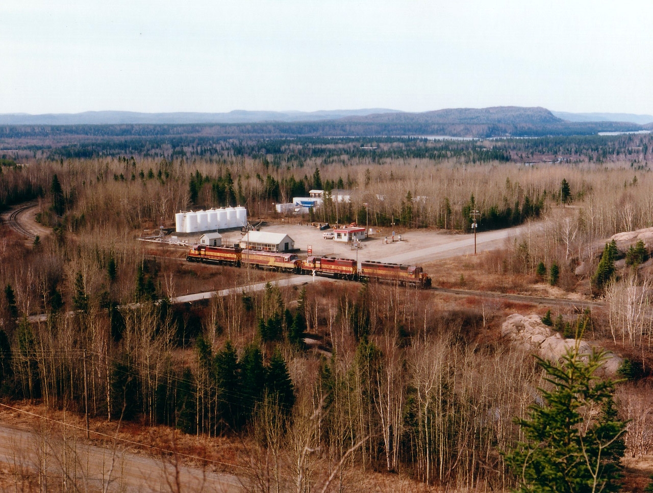 WC 6604, 6655, 3012 and 6506 are seen here at the west end of the yard at the great Wawa (Sinterville)Sinter Plant, enabling them to switch ore cars while at the facility. In the immediate foreground is Government Rd., which leads in from Wawa itself. I previously submitted an overview of the plant itself, photo #7796. Everything in the area, the operation itself, the huge plant, as well as the track for the whole subdivision was shut down and dismantled beginning not long after this photo was taken.