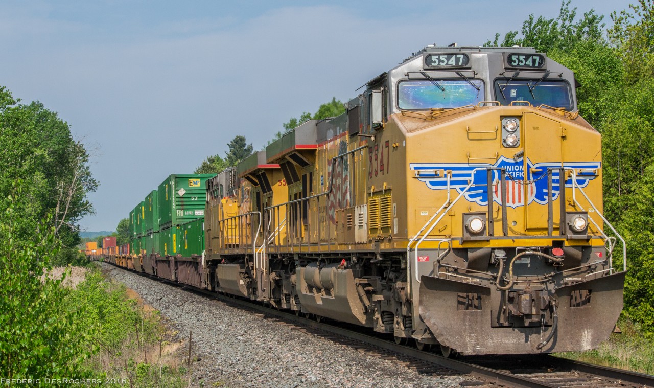 An Eastbound UP..I mean CP..stack train comes through Newtonville, en route to Montreal. 

UP 5547, UP 5507
