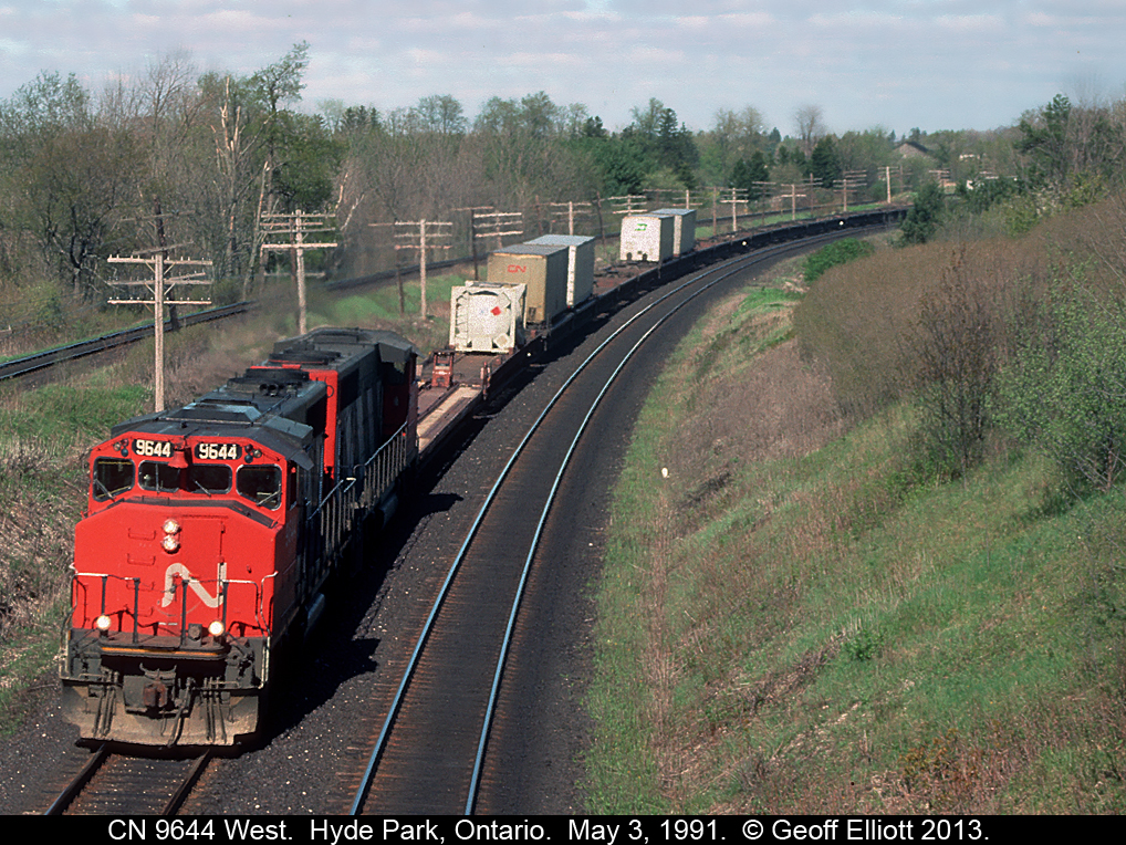 Missing the 'C' in CN, GP40-2W #9644 leads a westbound 'laser' train around the curve at Denfield Road late in the day.