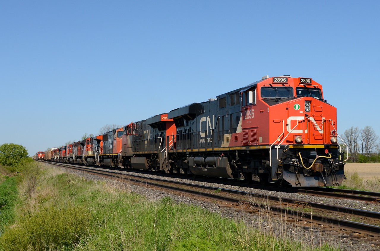 Train 396 led by CN 2896 with an incredible 11 unit lash up heads east bound out of Sarnia while the CN Test Train rolls alongside at Waterworks Sideroad.