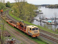 This Herzog tie train graced Huntsville Yard with its ugliness over the Victoria Day long weekend. The previous week a load of ties heading north in rickety old gondolas caught fire south of Gravenhurst and was suspected of igniting a half-dozen brush fires between there and around Mile 145 of the Newmarket Sub before smoke was noticed and the offending car cut out of the train and attended to by firefighters. The well-type cars used on this train appear to be a bit more fireproof. As a footnote, James Hoffman informs me that this contraption has an EMD 645 prime mover and a Leslie horn, so it sounds a lot better than it looks!