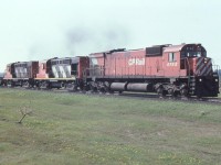 Over the years I've photographed trains there have been many interesting and odd-ball diesel units leased by Canadian Railways during power shortages. CP was noted for some of the most desperate attempts to find almost anything in running order. I consider the leasing by CP of a dozen or so CN MLW RS-18s in the spring of 1987 the most unusual situation. Rumors were they would become part of CP's locomotive rebuilding plan. CP 1842 had the car body from CN 3642. Two others (CN 3628 & CN 3663) were bought in 1992 but scrapped in 1995. The rest were returned to CN. In this photo we see CP 4742 leading CN 3659 and 3622 on an eastbound about two miles east of Bowmanville near the "fruit house". 