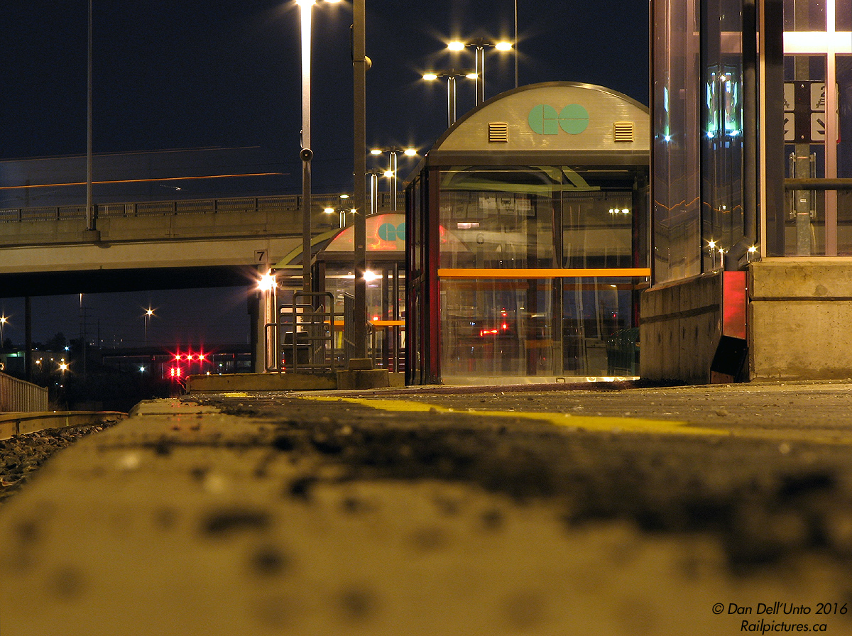 After the Rush: it's a quiet evening on the deserted platforms of Bramalea GO station. The last of the evening GO Trains has come and gone, and the reds lit up on the new signals on CN's Halton Sub near Highway 410 show no signs of freight activity - at the moment. Traffic zooms over on busy Steeles Avenue overpass overhead, and the odd GO and Brampton Transit bus pulls into the nearby bus loop to load/unload commuters.