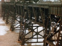 Nice combination of CN 2325, 2316 and 4414 crossing that big marsh down by Jordan Harbour heading toward Fort Erie. The marsh is an impressive body of water as seen from along the QEW, but averages only about 8 to 10 ft at its deepest spot. This image was taken from an old stone pier remaining from a parallel bridge built in the days of the Grand Trunk. The shot is no longer possible, and worse, the now present bridge railings do not do photography at this location any justice.  If any of you viewers followed the news a while back in which potential terrorists were plotting to blow up a railroad bridge, well this is the one. Only one freight each way and AMTK each way use the bridge daily now.