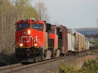 On a nice sunny spring afternoon/evening, CN 394 slowly makes its way towards CN MacMillan Yard while climbing the escarpment. This was also a lengthy train so it took a while to pass by; it was about to meet CN 2278 west which was CN 399 I think. Power on this train on this day was CN 3001-CN 3025. Time - 17:51.