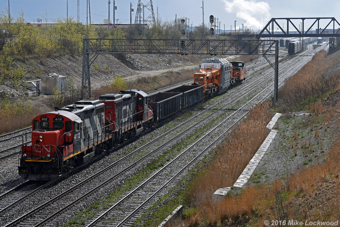 As a crew member lines the switches, CN 4112 and 7068 begin to shove 350's train into that yard at Oshawa Center. The D9 load on HEPX 200 made for a rather slow shove to the interchange at the auto compound to the south. 1633hrs.