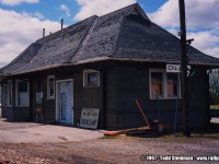 Last month and to my surprise, I found the Jarvis station on the move. When I was browsing through my collection, this photo brought me back to when I was a youngster. Typical CN fashion in the later years when they're stations needed maintenance...plain dull colours. Jarvis was painted in the dull grey, with blue and orange doors...plain and simple in design replacing the original wooden doors that seemed to be more fashionable in design. 
<br>
For those who have read my bio, it is this style that I still hold dearly to me...as plain as it is, it was still surprisingly appealing to me. 
<br>
Thankfully, the building was repainted when Michaud Fine Woodworking had owned the station. This design was more typically found on the CN's stations from the 50's...usually reversed with the red as the main colour on the building with cream trimmed windows. You can view the station at it's first stage of moving here: http://www.railpictures.ca/?attachment_id=23995#sthash.y2bCDtOD.dpuf 
<br>
Of note...the tracks and station aren't the only thing that have or will be disappearing...in the background, to the left, is the old railway hotel which burned down a short time after this photo was taken.