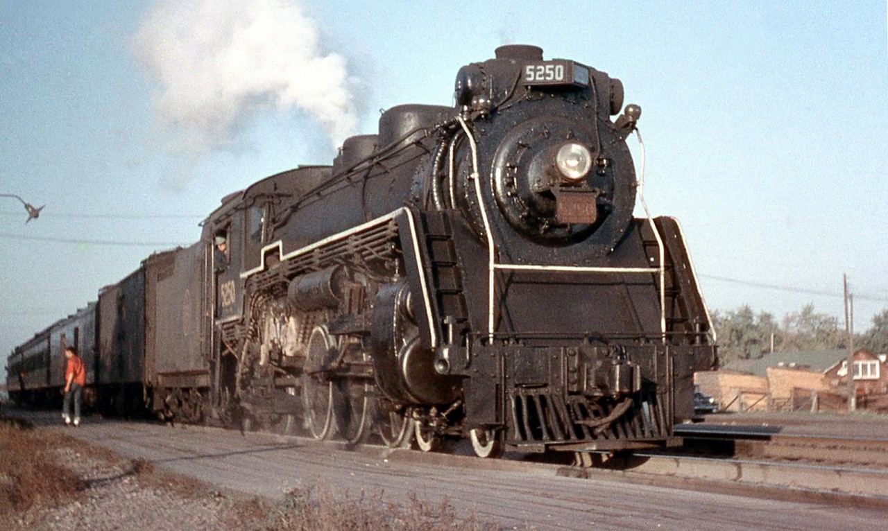 A late afternoon Canadian National commuter train from Toronto stops at Port Credit Station in 1957. Power today is CNR 5250, the first of the J-7-a class Pacifics built by MLW in 1918 (originally built as Canadian Governmental Railways 478). As dieselization progressed on Canadian railways in the mid-late 1950's, the remaining steam power was often found in or relegated to less glamourous duties, including commuter runs, freight service, local assignments, pusher/helper service (like CP 2839 *here*) and extra/standby duties. 5250 was scrapped the next year in June 1958.