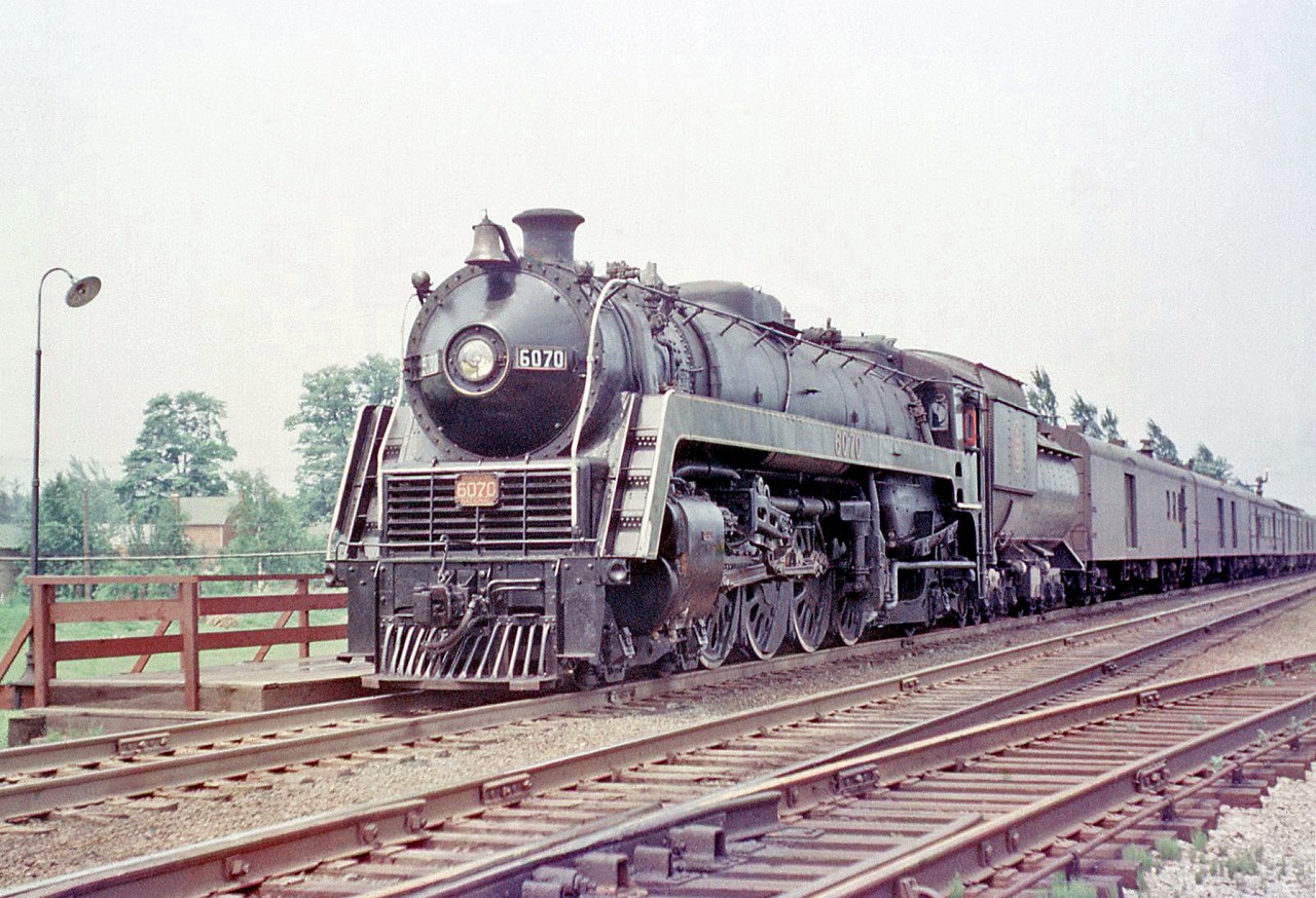 Canadian National 4-8-2 6070 (one of CN's famed U1f class "Bullet Nose Bettys") stops at Port Credit Station with a passenger train in 1956.