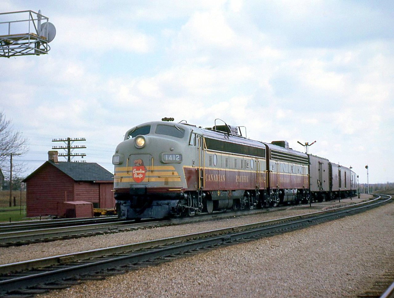 The last run of Canadian Pacific train #21, with CP FP9 1412 leading an F7B, is shown at Guelph Junction station (note the platforms and semaphone signals behind the train) on April 25th 1964. CP #21 was a long established full service train that ran from Montreal to Toronto, and on to Windsor and Detroit. Then transferred to Michigan Central to Chicago. The CP timetable referred to it as the "Chicago Express". All trains after (except the "Canadian") would be RDCs.