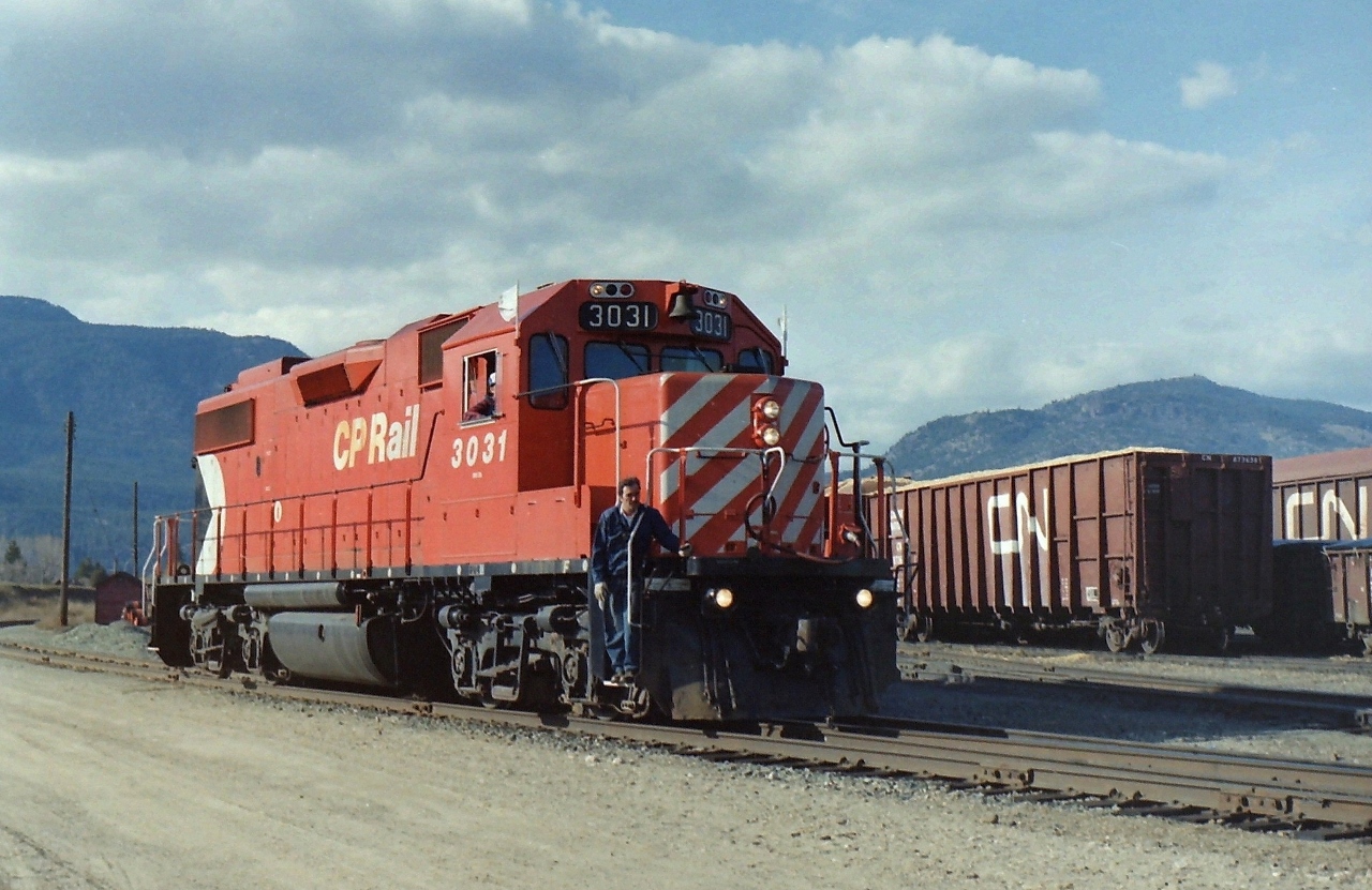 During the 1980's the railway scene in Kelowna was interesting. I always seemed to find a CP or CN unit somewhere in the yards. On this particular day CP 3031 was moving cars around the area near me. I took around 3  photographs CP 3031 before moving on. I like this picture because it shows the human side of day to day railway operations. Parking near there was never an issue, & there was a small hill that you could climb to get a better view of the yards. At the time I had the impression that there was enough local business to keep the railways busy for years, but sadly I was wrong! The days before the idiots with spray cans, & no respect for the railways were great.