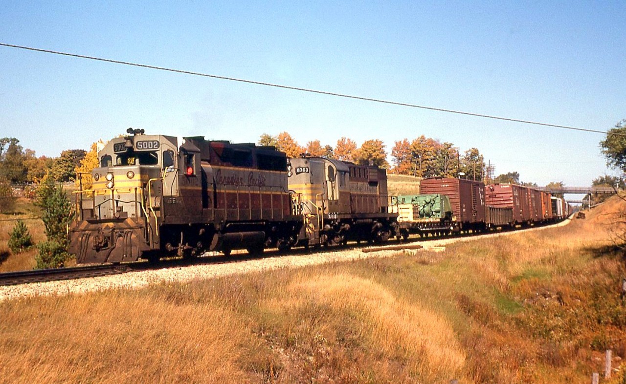 CP 5002 West with GP35 5002 leading RS18 8763 round the curve at Mile 55.3 of CP's Galt Sub (just east of Killean siding), near Clyde Road in October of 1966.