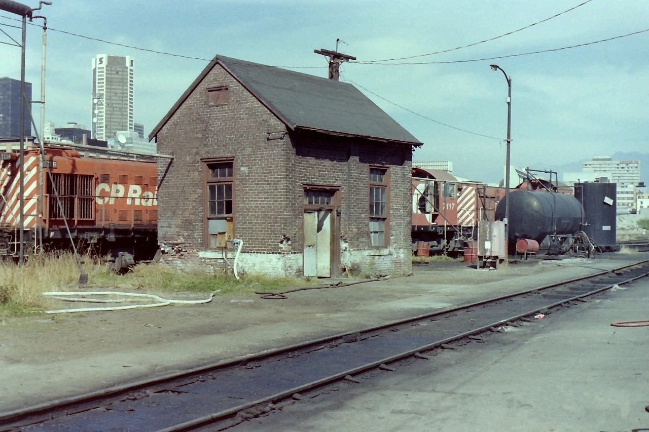 The oil house building shown in the picture is a very small, but important piece of Vancouver railway history. CP locomotives 7113/7117/7116/7094 were sitting behind the building, but the area in front of it was clear which allowed for a good photograph. To the right of the building is the lube oil tank, & the waste oil tank. All in all there is a lot of history in the picture. The brick oil house was made to last, & by it's looks it took a pounding over the years. I took many pictures of railway buildings over the years because I felt that they were also an important piece of history. Today buildings like this are long gone! I have to thank my friend Andy Cassidy for telling me what the building, & the tanks were used for.