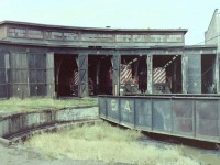  This photograph shows the locomotive entrances to stalls 3 to 9 at the CP Drake St roundhouse in Vancouver BC. These were the main working stalls of the building in 1981. Stalls 10 to 12 (not shown)were used as the diesel shops. The remaining un-numbered portions of the roundhouse, & some areas of the back shop were used by CP Transport for vehicle servicing. These were the dying days of CP activity at the Drake St site. As you walked around the area you could see where many of the tracks had been recently removed, & ground preloading for Expo 86 was well underway. Today the area of the roundhouse once occupied by stalls 3 to 12 still exist, but with a completely different use being applied to it. 