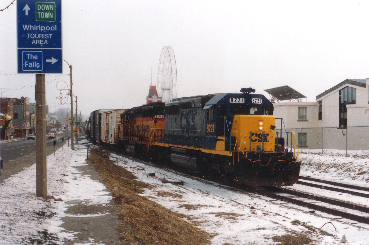 It might have been a dull and damp March day, but I warmed up quickly when I saw this version of #321 rolling thru Clifton Hill. Not often did I see a clean yellow nose CSX 6221, my favourite of their paint schemes, followed by 'the cat' 6218. CSX had only 5 more years of running their trains thru Niagara, and the rail line itself would be gone by 12/2001 to make way for a Casino.