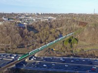 GO Transit's most scenic line, but also the most treacherous, has to be the Richmond Hill line. This mostly includes the section between Mile 2 and 10 of the former CN Bala Subdivision. The line traverses parallel to the Don River for most of that distance, and that ends right here. Slugging along at a steady 35mph, GO 837 crosses over the Don Valley Parkway, after having previously crossed under it further south just a few minutes prior. On the right behind where the GO train disappears, the CP Belleville Sub crosses over. A second train would be nice, but there's obviously a fat chance of that. The famous rainbow tunnel was painted by Norwegian artist Berg Johnson in 1972, who dangerously suspended himself from the Bala Sub. Some say a train came by and cut the rope, causing him to fall and hurt himself, which wouldn't surprise me. Nonetheless, the locals have done what they can to keep the tunnel art in good condition. The Don Valley Parkway in the foreground is experiencing the rush hour crush, which certainly is not doing a good job keeping up with the GO train. 