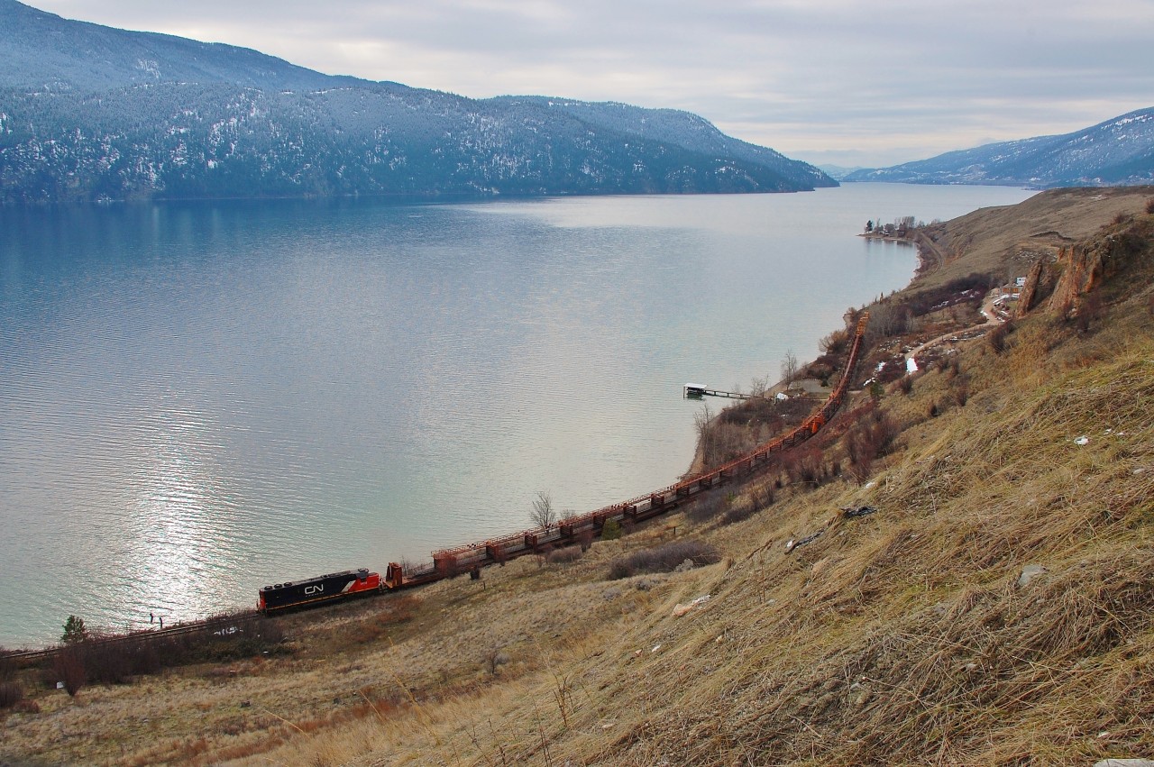 CN 5428 is in charge of the work train that is lifting track between Vernon and Kelowna. This shot is taken near Kekuli bay on Kalamalka Lake.