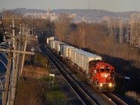 <b>A GP38-2 leading Canada's only piggyback train.</b> GP38-2 CP 3129 is leading the westbound Expressway (CP 133) through Pointe-Claire, with AC4400CW CP 8642 trailing. CP 133 and its eastbound counterpart CP 132 leave their terminals in Montreal and Toronto respectively in the evening and arrive at their destination at about 5 in the morning. They are the only piggyback trains running in Canada. While you would expect a hot train like this to be the exclusive domain of six-axle power, 4-axle geeps have been quite common on these trains this year and last year.
