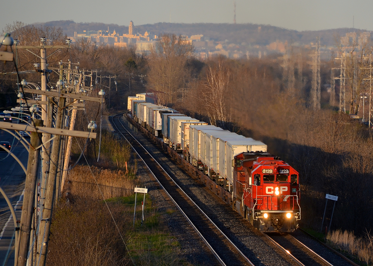 A GP38-2 leading Canada's only piggyback train. GP38-2 CP 3129 is leading the westbound Expressway (CP 133) through Pointe-Claire, with AC4400CW CP 8642 trailing. CP 133 and its eastbound counterpart CP 132 leave their terminals in Montreal and Toronto respectively in the evening and arrive at their destination at about 5 in the morning. They are the only piggyback trains running in Canada. While you would expect a hot train like this to be the exclusive domain of six-axle power, 4-axle geeps have been quite common on these trains this year and last year.