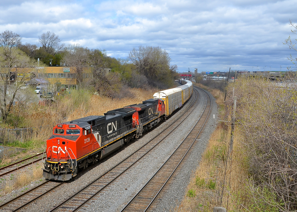 Sometimes all you need is 5 seconds. On an almost entirely cloudy afternoon, I was lucky enough to have about 5 seconds of sun just as the head end of CN 401 approached the St-Jacques overpass.... by the time the trailing unit passed under me it was already cloudy again. Power is a pair of ex-ATSF Dash8-40CW's: CN 2139 & CN 2182 (originally ATSF 808 & ATSF 841 respectively).