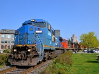<b>Traces of Conrail.</b> The only units left on Class I's that are still in Conrail blue plaint since Conrail days are the ex-LMSX IC Dash8-40CW's on CN, which initially were leased units shared by Conrail and CN. While a few have been repainted into CN colours, most solider on in rather faded Conrail blue. Here IC 2456 (ex-LMSX 729) leads an IC unit in CN paint (IC 2705) and CN 8851 as CN 149 slowly leaves the Port of Montreal on a gorgeous morning.