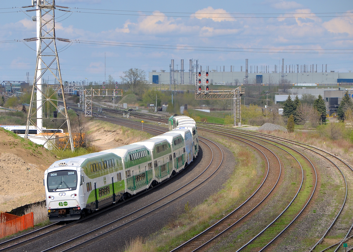 A cab car that almost looks like a locomotive. A fairly new cab car (GOT 304) leads a westbound GO Transit train through Whitby, with GOT 616 pushing.