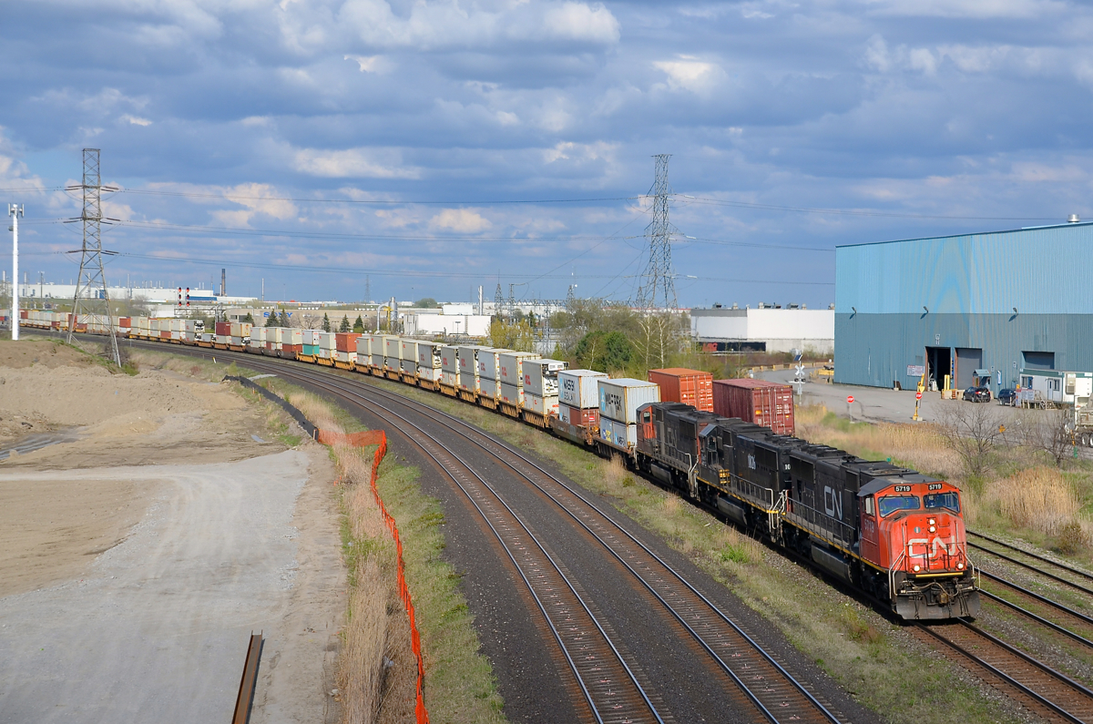 A trio of EMD's. CN 149 has a getting much rarer lashup composed of three EMD's, with SD75I's CN 5719 & CN 5784 sandwiching SD70 IC 1026. The train is approaching the Hopkins street overpass, which is slated to be closed very soon and eventually demolished to make way for a GO Transit servicing facility which is already under construction on both sides of the street. Visible at right is the tail end of CN 148, CN 149's counterpart.