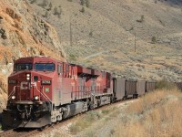 A heavy CP coal train rolls along CNès Ashcroft Sub on a hot August day along the Thompson River.