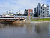 <b>Non-stop Amktrak heritage units in Montreal.</b> For about the 6th time in 2 weeks, an Amtrak heritage unit is seen leading the <i>Adirondack</i>. Both AMTK 184 and AMTK 822 (the latter seen here pushing the <i>Adirondack</i> towards Central Station in Montreal) have visited Montreal very often recently. Behind the train is Montreal's ever changing skyline, with a number of cranes prominent behind Wellington Tower.