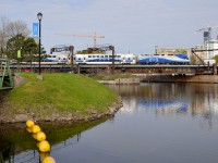 <b>A Mascouche train south of Central Station.</b> It's rare to see AMT trains from the Mascouche line passing Wellington Tower, as they mostly lay over north of here during the day. But when they need to be serviced in Pointe St-Charles they head south of Central Station, as here where AMT 1363 is pushing the consist to Pointe St-Charles for servicing.