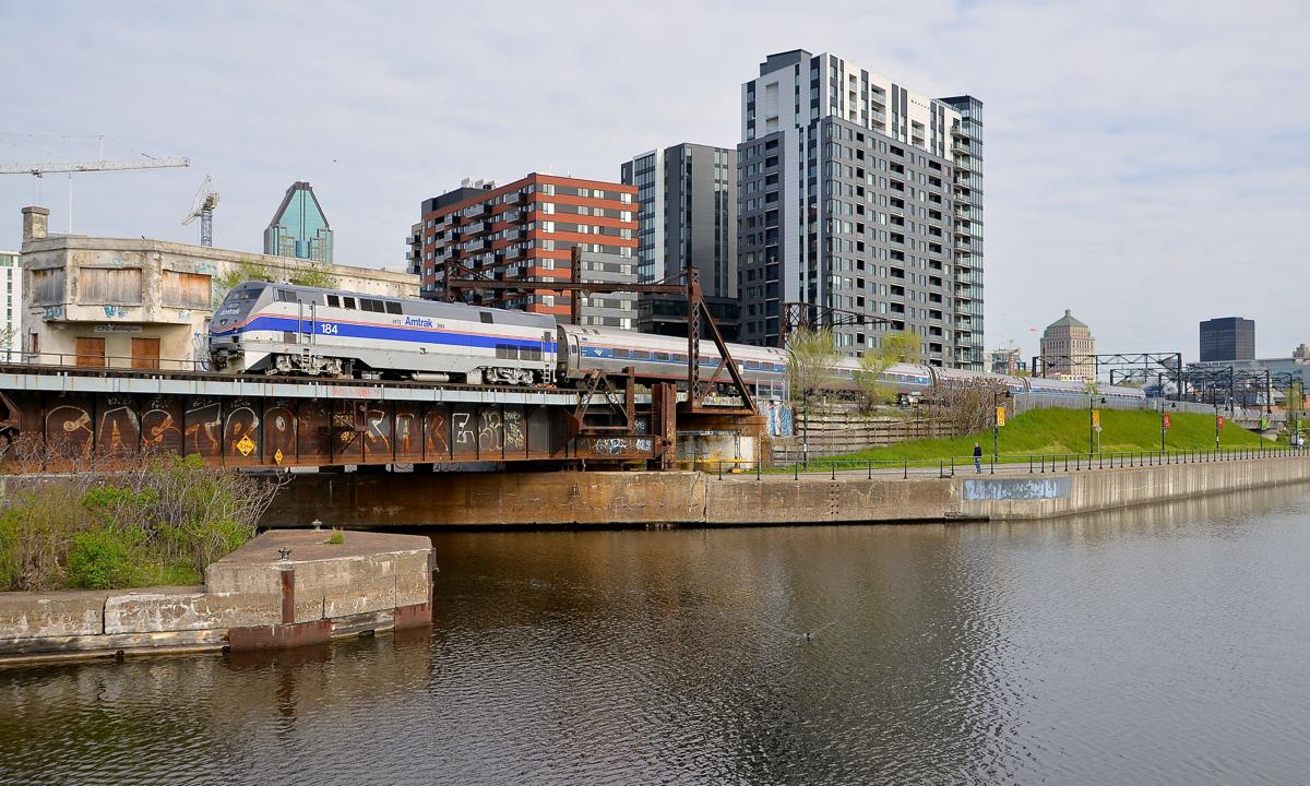 Another morning, another heritage unit A day after heritage unit AMTK 822 led the Adirondack in Montreal, another heritage unit performed the honours this morning. Here AMTK 184 is pushing the Adirondack past Wellington Tower.