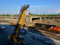 <b>Past where the tunnel used to be.</b> The DPU on potash train CN B730 (CN 2848) is passing the site of a tunnel on CN's Montreal sub that was removed about a week ago. Part of the tunnel is still visible behind the train, as it was lifted off the tracks in pieces over a few weeks.