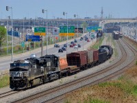 <b>3 NS-led trains in the same shot in Montreal.</b> It was quite an NS extravaganza on CN's Montreal sub this afternoon. In this shot we see a very short CN 527 heading west on the freight track at left with NS 8004 & NS 9443. On the next track over (the north track) the tail end of CN 528 is visible, it was powered by 4 NS units. Finally on the south track at right we see the headlight of CN 323, returning from Vermont with NS 1134 & NS 8972 for power.