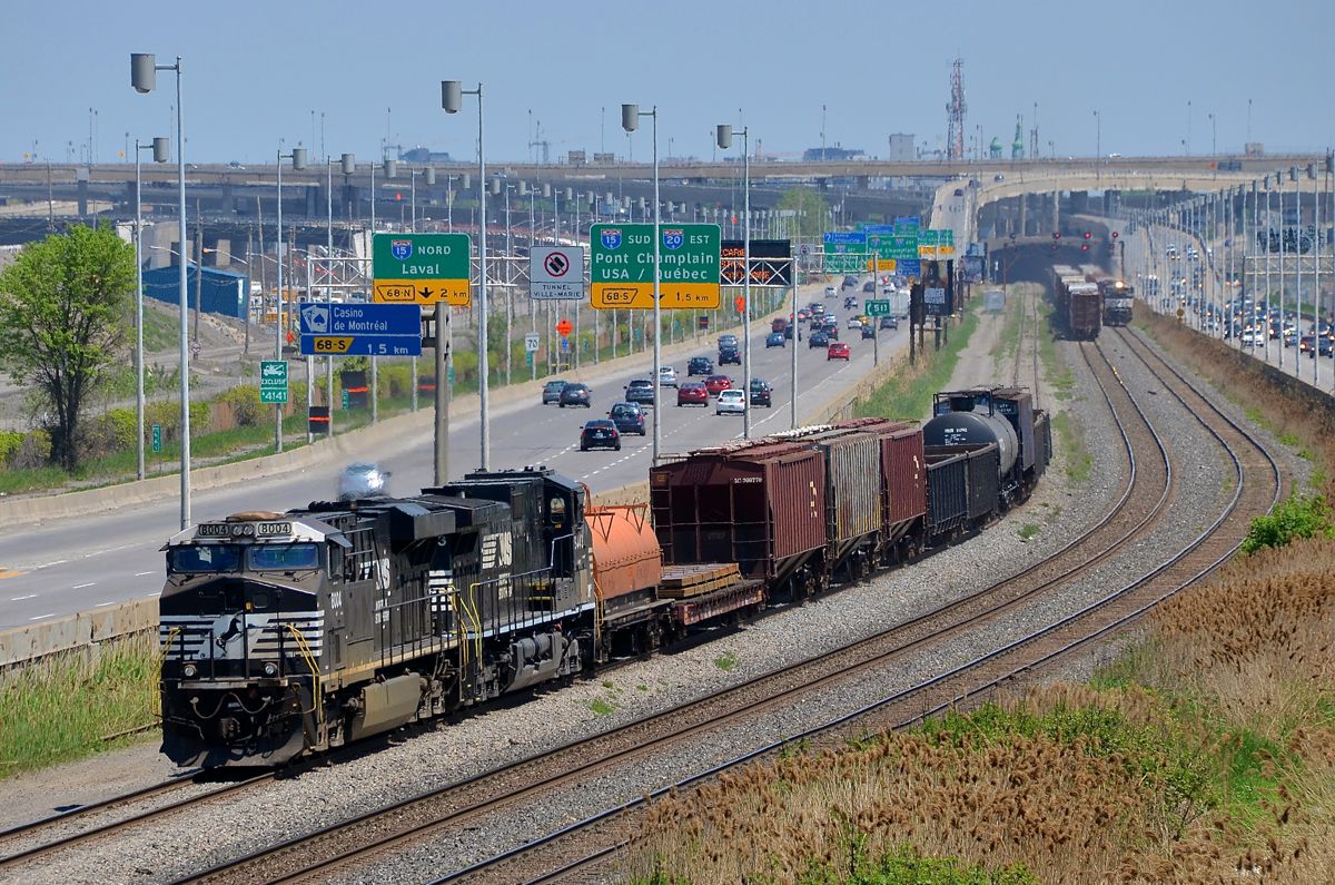 3 NS-led trains in the same shot in Montreal. It was quite an NS extravaganza on CN's Montreal sub this afternoon. In this shot we see a very short CN 527 heading west on the freight track at left with NS 8004 & NS 9443. On the next track over (the north track) the tail end of CN 528 is visible, it was powered by 4 NS units. Finally on the south track at right we see the headlight of CN 323, returning from Vermont with NS 1134 & NS 8972 for power.