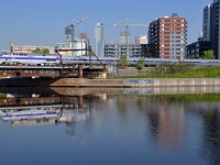 <b>A phase IV unit reflected.</b> Phase IV heritage unit AMTK 184 is reflected in the mostly still waters of the Peel Basin as it pushes the deadheading <i>Adirondack</i> towards Montreal's Central Station. This is about the fifth or 6th time this unit has been to Montreal in the month of May.
