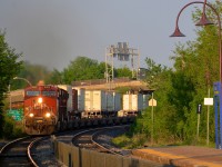 <b>Piggybacks around a curve.</b> CP 9352 leas CP 133 around a curve as it approaches Valois station.