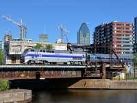<b>Amtrak heritage back in Montreal two days later.</b> Two days after leading the southbound <i>Adirondack</i> out of Montreal, heritage unit AMTK 184 is on the same run. Here it pushes the deadheading train towards Central Station as it passes Wellington tower about 75 minutes before departure from downtown Montreal.