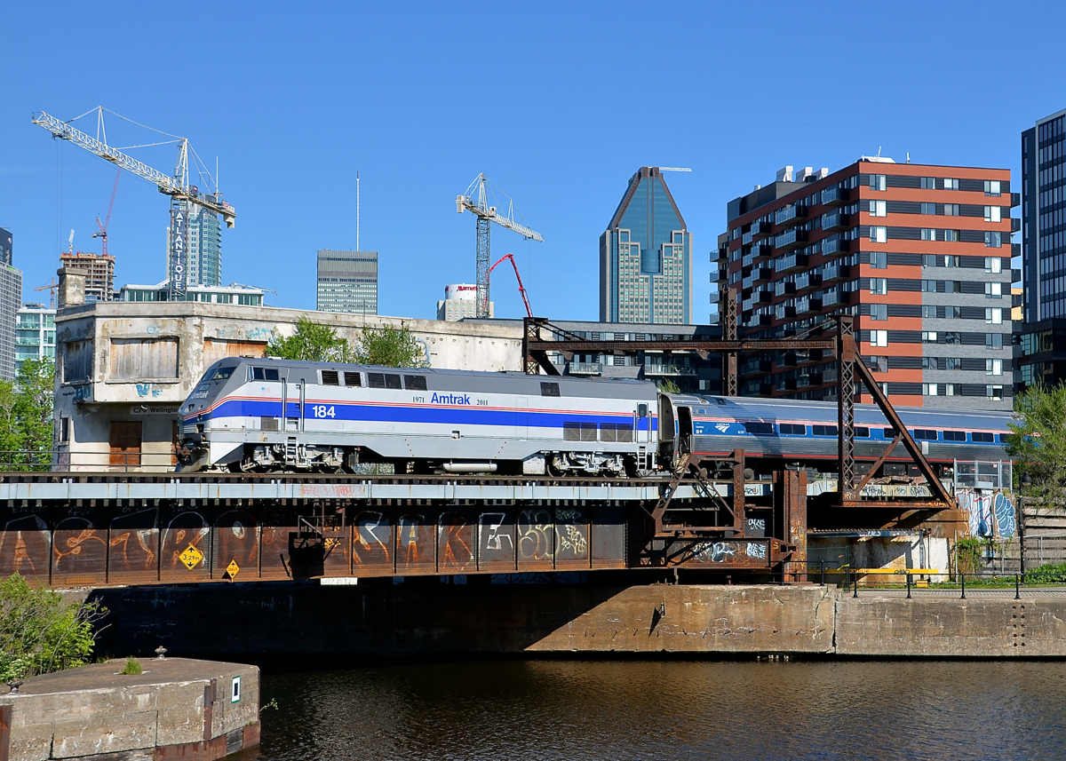 Amtrak heritage back in Montreal two days later. Two days after leading the southbound Adirondack out of Montreal, heritage unit AMTK 184 is on the same run. Here it pushes the deadheading train towards Central Station as it passes Wellington tower about 75 minutes before departure from downtown Montreal.