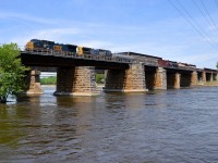 <b>A pair of Dash8-40CW's, in two paint schemes.</b> Two CSXT Dash8-40CW's (CSXT 7808 & CSXT 7884) in two different paint schemes lead a short CN 327 (292 axles) off the island of Montreal on a scorcher of a day.