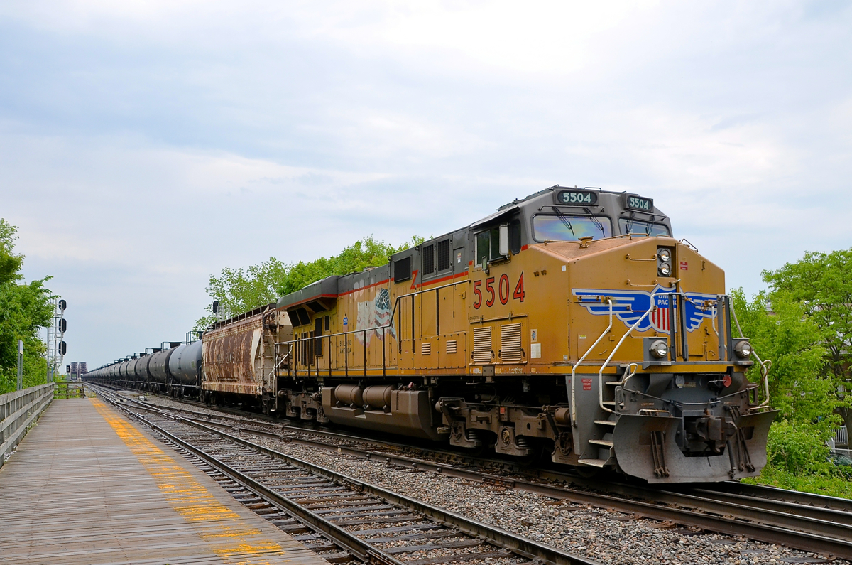 UP 5504 brings up the rear of loaded oil train CP 550 as it passes the platform at Lasalle station. Up front was another UP unit - UP 5422.